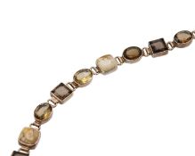 A silver bracelet with gemstones.