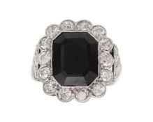 An Art Deco style black onyx and diamond dress ring set in white gold.