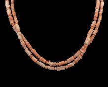 A blush pink coral necklace with a 14k gold clasp.