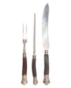 A Victorian oak cased silver-mounted antler handle carving set by Harrison Brothers & Howson.