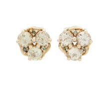 A pair of 9k gold, csarite (Turkish diaspore), and tsavorite garnet stud earrings.