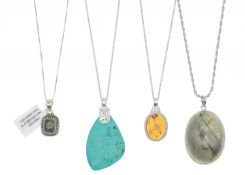 A selection of four silver pendant necklaces.