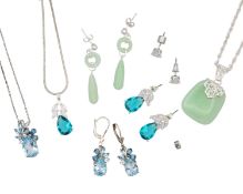 Three sets of silver pendant necklaces with earrings, in a small travel jewellery box.