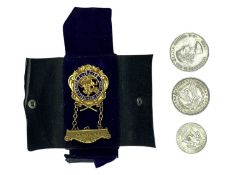 A Masonic P.W.P. gold-plated jewel, a USA 1889 Morgan silver dollar and two other coins.