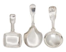 A selection of three Georgian silver caddy spoons with fiddle handles.