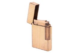 A Dupont lighter, of rectangular form with reeded design, gold-plated, signed and numbered.