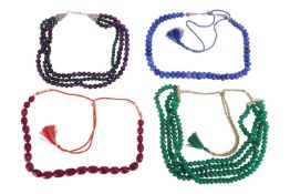 Four beaded necklaces; to include a row of graduated glass-filled ruby beads carved as foliate to a 