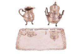 A German milk jug, a matching twin-handled sugar bowl and an unassociated tray; the milk jug and sug