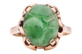 A carved jadeite ring; the oval-shaped carved jade depicting fruits, approximately 12.0 x 10.0 mm, i