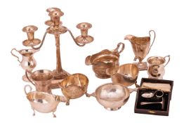 A collection of silver items to include; a George III helmet-shaped cream jug with bright-cut decora