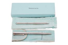 Two Tiffany & Co. ballpoint pens together with a silver bonbon pedestal dish; the 'T' clip ballp