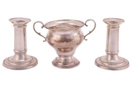 A pair of Victorian silver short candlesticks with nozzles, 10.8 x 8 cm; and an Edwardian silver sma