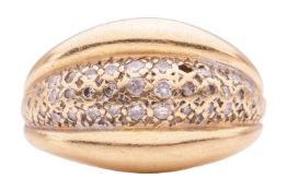 A diamond-set dress ring, featuring three domed rows, centrally-set with round brilliant diamonds of
