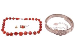 A group lot of items to include; a Middle Eastern white metal woven belt with an adjustable hook buc