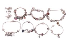 A quantity of Pandora sterling silver jewellery; to include five snake chain bracelets featuring var