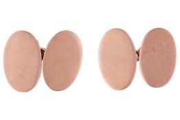 A pair of oval panel cufflinks, connected with cable links, yellow metal stamped 