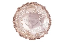 A silver presentation bowl by Walker & Hall, Sheffield 1935; the pedestal bowl with fruiting vin