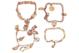 Four charm bracelets; comprising heart padlock charms, 9ct kidney bean charms and other, to 9ct and 