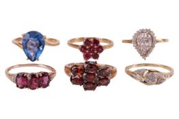 A group of six gem-set rings in 9ct gold; comprising a pear-shaped blue paste ring, set to crossover