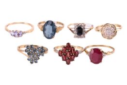 A selection of seven gem-set rings in 9ct yellow gold; including a garnet lozenge cluster ring in si