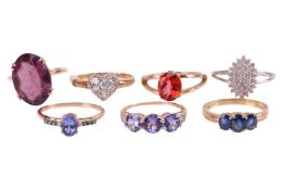 A group of seven gem-set rings; to include examples of a red mystic topaz ring between bifurcated sh