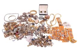 A large group of costume jewellery, comprising an engraved white metal locket and chain, a charm bra