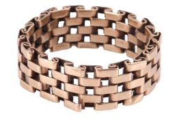 A lattice work ring, comprising five rows of flexible panther links, in unmarked yellow metal testin