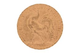 A France 1904 gold 20 Francs coin with Marianne wearing the Phrygian cap on the obverse, and a cock 