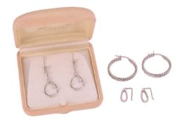 A group of white gold earrings; the first a pair of 9ct white gold hoop earrings of stylised texture