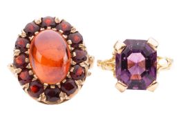 Two paste dress rings; to include a red paste cluster ring, centred with a hollow dome encircled wit