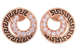 A pair of enamel stud earrings, of swirl design, edged with a black enamel Greek key border, and fur