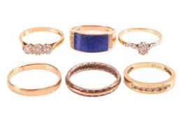 A group of six rings; to include an 18ct diamond trilogy ring set with three round brilliant cut dia