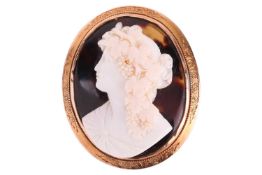 A large 19th-century cameo brooch; the shell cameo of a side profile of a bacchante, applied on a to