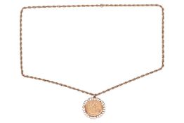 A Queen Victoria full sovereign pendant on chain, dated 1887, in a 9ct yellow gold scrolled mount, t