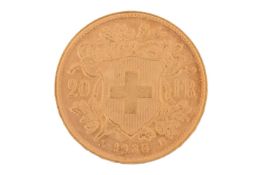 A Switzerland 1935 gold 20 Francs coin with Helvetia facing left, Swiss Cross in shield on the rever