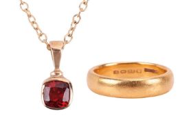 A garnet pendant on chain, and a 22ct gold wedding band; the pendant collet-set with a cushion-shape