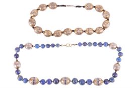 Two ethnic beaded necklaces; to include a single row of graduated round lapis lazuli beads, interspa