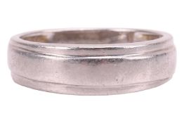 A band ring of plain design with stepped profile, in white metal testing as platinum and marked '950