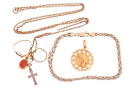 A mixed collection of jewellery items including an Egyptian-style pendant marked '750', a fancy-link