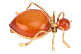 An amber brooch in the form of an insect, set with two large cabochons as head and abdomen, brooch f