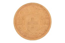 A Switzerland 1935 gold 20 Francs coin with Helvetia facing left, Swiss Cross in shield on the rever