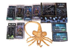 A collection of Alien collectibles, to include - Neca Facehugger, Reel Toys Alien Xenomorph (367N080