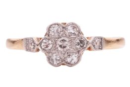 A diamond-set floral cluster ring; the daisy head set with seven single-cut diamonds, with millegrai