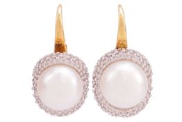 A pair of pearl and earrings; each featuring a central cultured akoya pearl of approximately 8.5mm, 