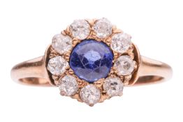 A late Victorian garnet-topped-doublet and diamond cluster ring, centred with a circular-cut blue GT