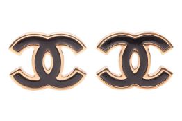 Chanel - a pair of CC earrings, circa 2024, with black resin inset within a gold-tone hardware, ear 