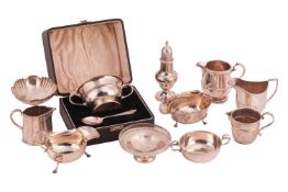 A small group of items comprising two silver sauce boats, three silver cream jugs and one silver pla