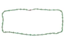A jade bead necklace, comprising an array of round jadeite beads alternating with size 7.3 mm and 10