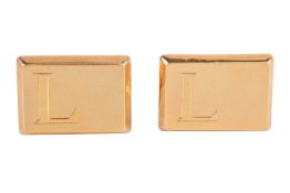 A pair of cufflinks, in yellow metal marked '18ct', of rectangular form with bevelled edge, the brus