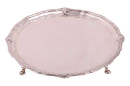 A silver salver by Adie Brothers, Birmingham 1925, of circular form with piecrust rim and scrolled d